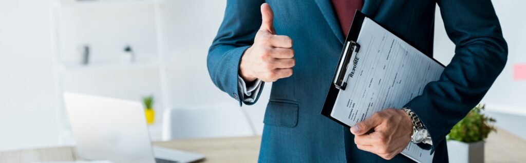 panoramic shot of recruiter standing and holding clipboard with resume letters while showing thumb